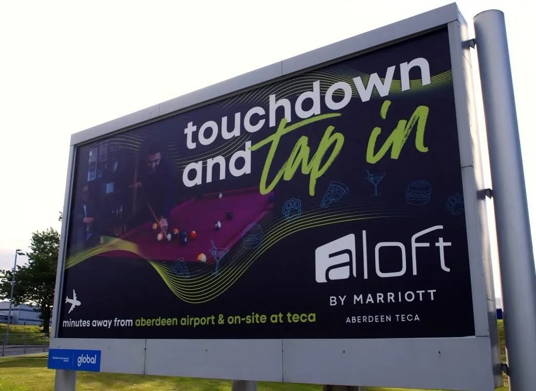 The installed Aloft airport banner seen from the approach road